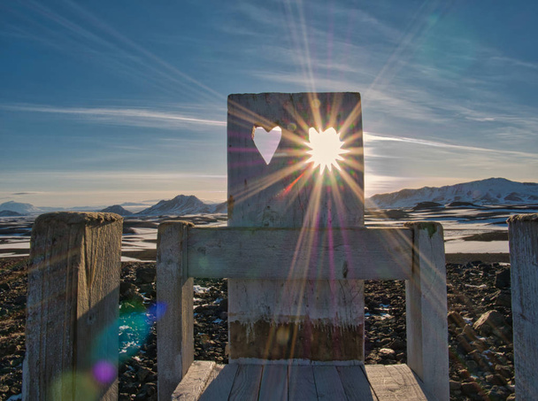 Sunbeams shine through the heart in the stool - Photo, Image