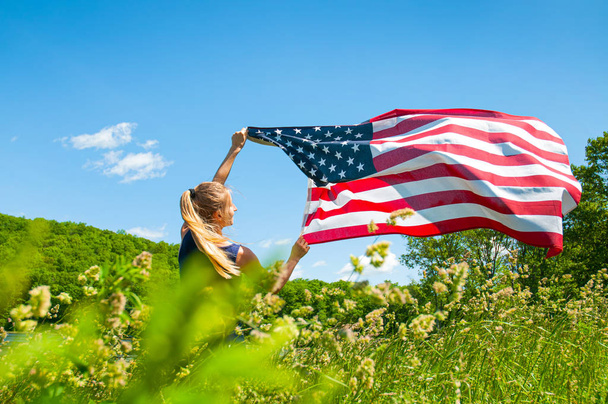 Woman holding American flag outdoors. United States flag, 4th of July  - Foto, Imagen