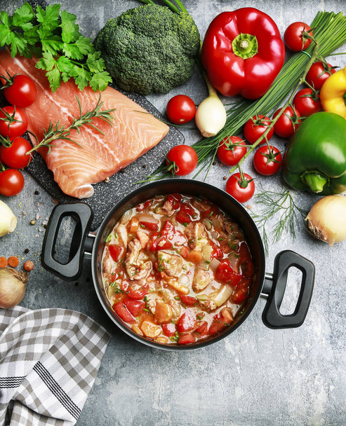 Goulash soup, salmon fillet and colorful vegetables - Foto, afbeelding