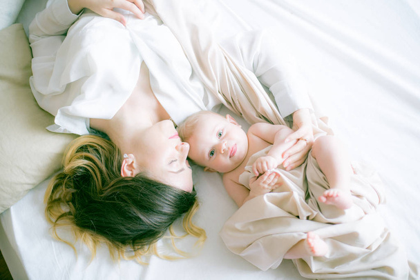 happy family. mother playing with her baby in the bedroom - 写真・画像