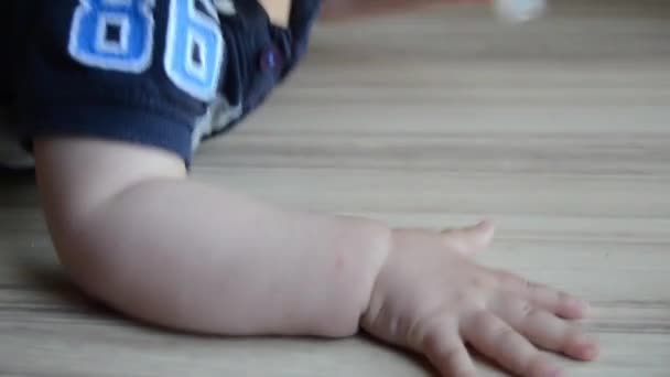 sevimli yedi ay eski bebek çocuk yerde kukla ulaşmaya çalışıyor - Video, Çekim