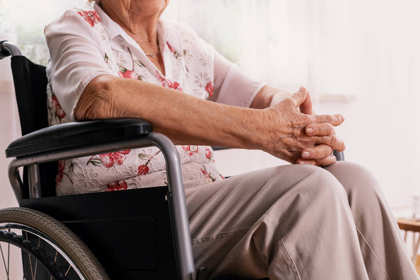 Elderly woman sitting on wheelchair at nursing home - Foto, Bild