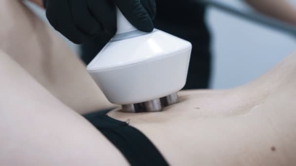 Close up, woman stomach during rf lifting therapy in medical clinic, slow motion - Imágenes, Vídeo