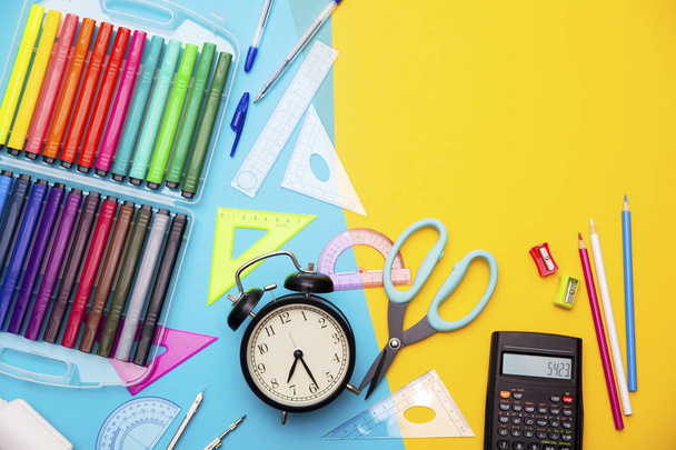 Starting school, back to school, education are styled flat lay scene with school supplies on blue and yellow - 写真・画像