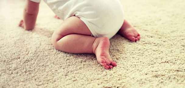 little baby in diaper crawling on floor at home - Fotoğraf, Görsel