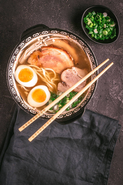 Udon Noodles in Japanese Ramen Soup with Pork, Eggs and Scallion on Dark Background - Valokuva, kuva