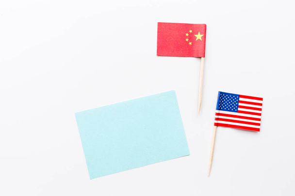 Creative top view flat lay of China and USA flag, mockup and copy space on white background in minimal style. Concept of trade war between USA and China - Fotoğraf, Görsel