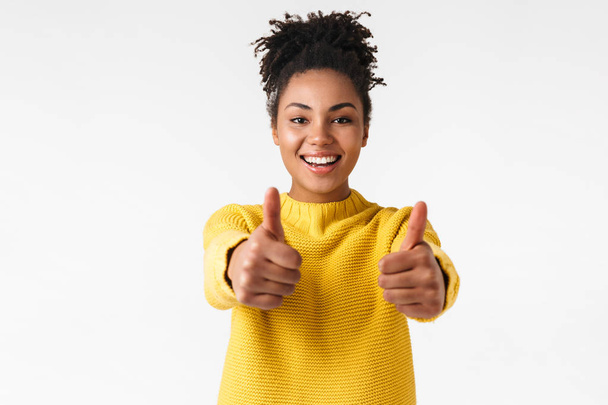 Beautiful young african happy woman posing isolated over white wall background make thumbs up. - Фото, зображення