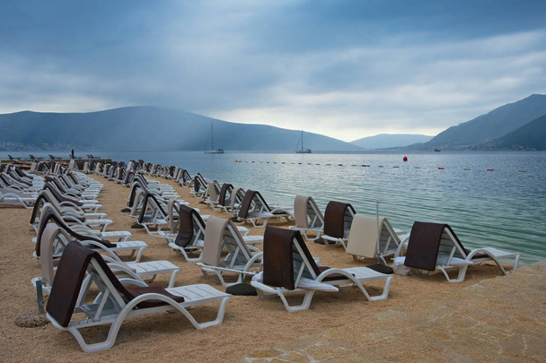 Pochmurny dzień na plaży. Czarnogóra, Morze Adriatyckie, widok na zatokę Kotor w pobliżu miasta Tivat - Zdjęcie, obraz