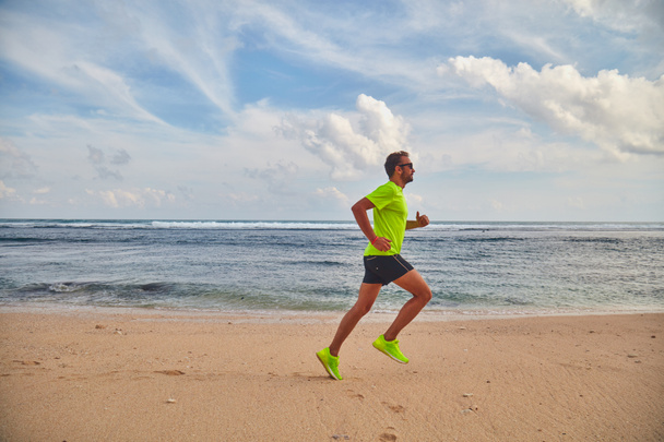 Man running / jogging on a tropical exotic beach. - Фото, зображення