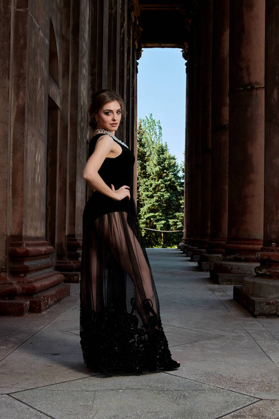 Young woman is wearing a sexy transparent black dress. Young woman modern portrait. - Photo, Image