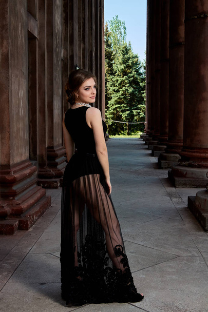 Young woman is wearing a sexy transparent black dress. Young woman modern portrait. - Foto, Imagen