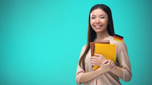Cheerful woman holding German flag book, education abroad, learning language - Filmagem, Vídeo