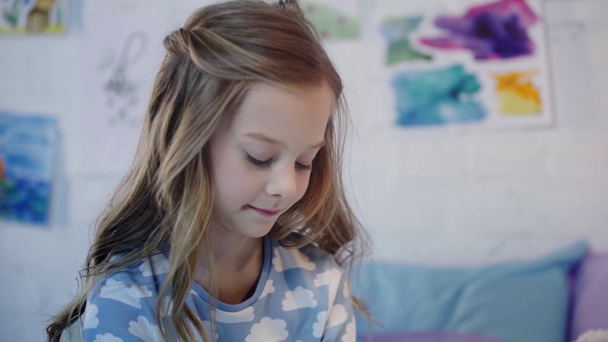 cute kid in pajamas holding cup and drinking beverage in bedroom - Footage, Video