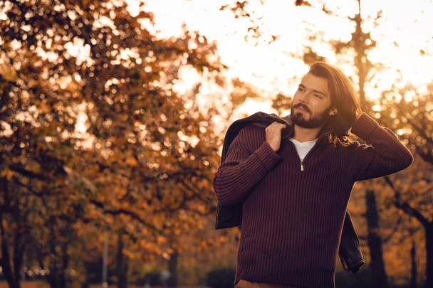 schöner junger Mann mit Lederjacke in der Herbstzeit / kaltes Wetter. - Foto, Bild