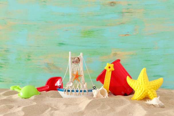 vacation and summer image with beach colorful toys for kid over the sand - Φωτογραφία, εικόνα