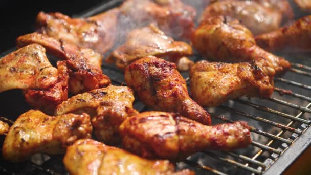 Delicious chicken pieces frying on barbecue grill - Footage, Video