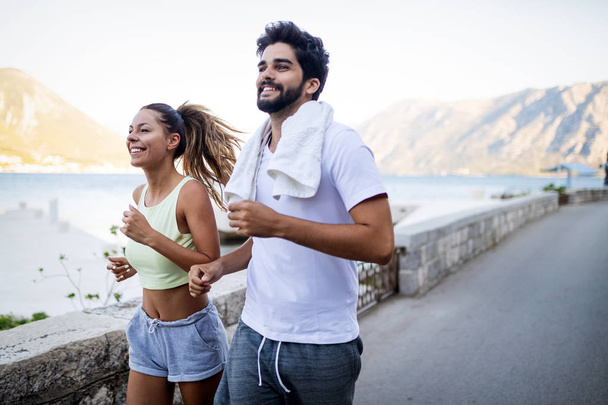 Happy fit people friends exercising and running outdoor. Healthy sporty lifestyle. - Φωτογραφία, εικόνα