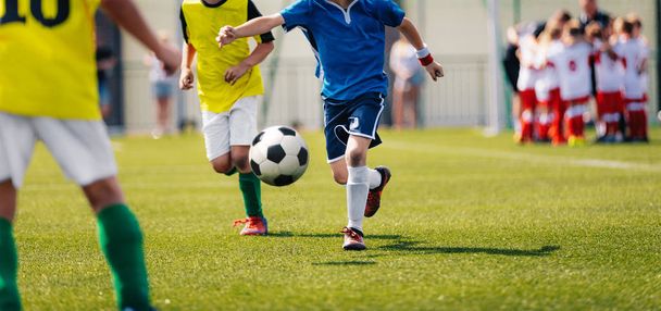 Children Playing Soccer Game During Primary School Soccer Tournament - 写真・画像
