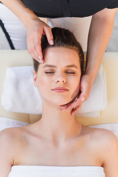 Young female masseur making massage for young client. - Fotografie, Obrázek