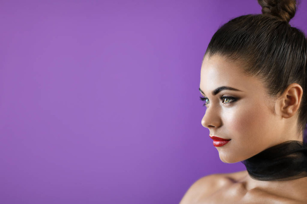 Brunette model with red lipstick on purple cover background - Φωτογραφία, εικόνα