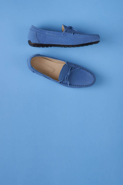 Blue suede man's mocassin shoes over blue background - Zdjęcie, obraz