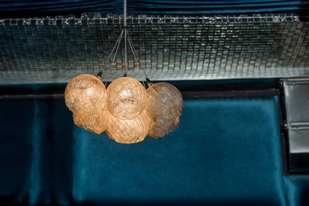 Round wicker chandeliers. Decorative chandeliers in the restaurant. Lighting in the room. - Photo, Image