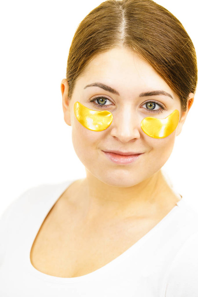 Woman with gold patches under eyes - Photo, Image