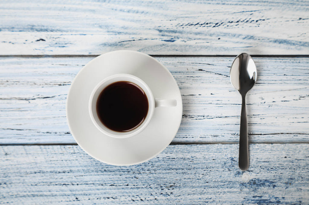 cup of coffee and teaspoon on grey table - Foto, afbeelding