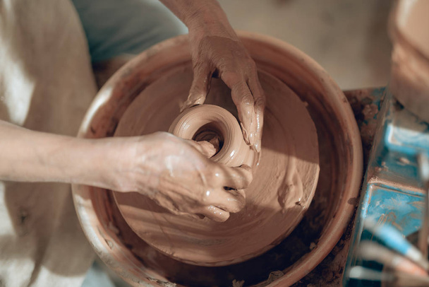 Top view of female hands shaping bowl at workshop - Fotografie, Obrázek