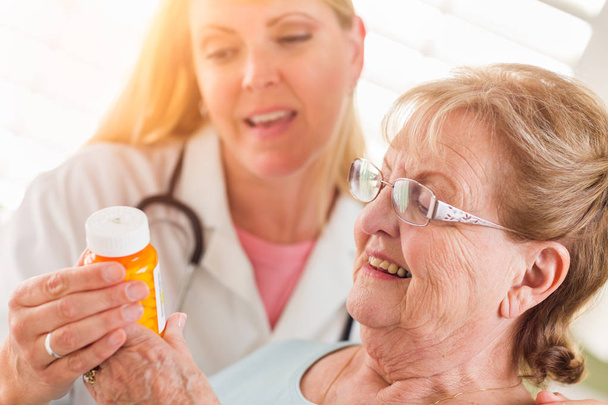 Happy Female Doctor or Nurse Explaining Prescription to Senior Adult Woman - Fotó, kép