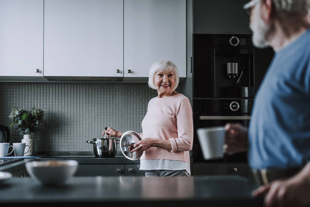 Happy elder couple spending time on kitchen - Foto, immagini