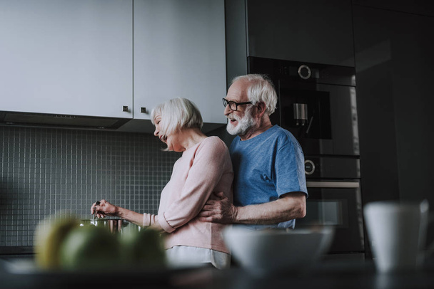 Happy senior couple cooking on kitchen at home - Foto, imagen