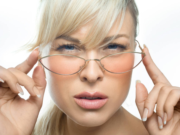 The girl with bad eyes attentively looks through glasses. Eyes health concept. - Foto, Bild