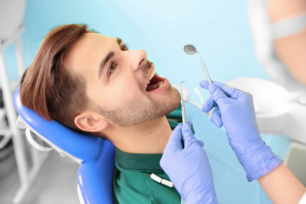 Professional dentist working with patient in modern clinic - Zdjęcie, obraz