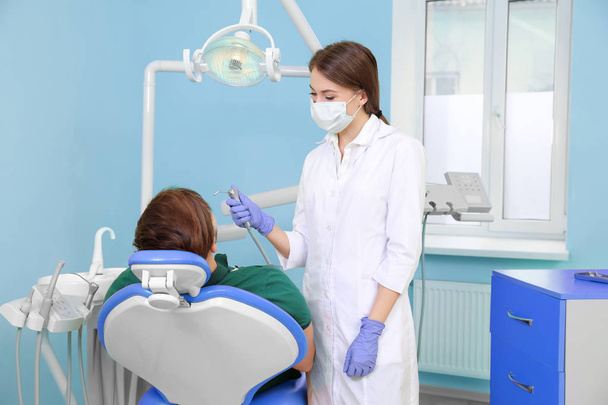 Professional dentist working with patient in modern clinic - Foto, afbeelding