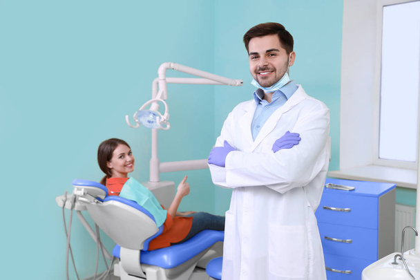 Professional dentist and patient in modern clinic - Foto, Imagen