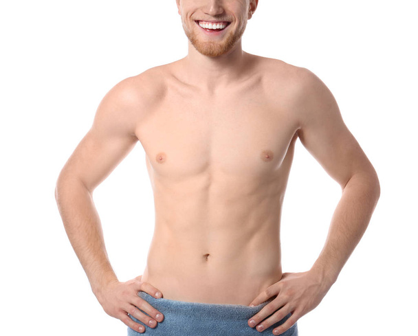 Young man with slim body in towel on white background, closeup - Фото, зображення