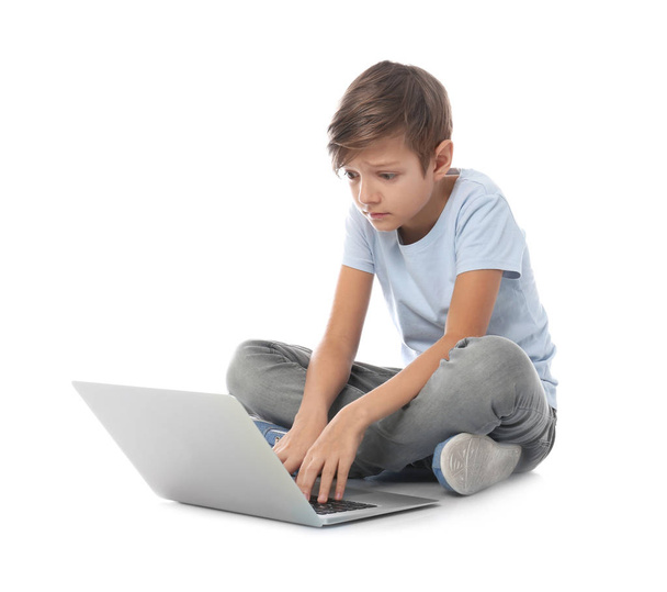 Shocked child with laptop on white background. Danger of internet - Valokuva, kuva