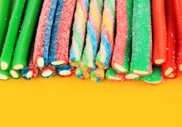 Sweet jelly candies on yellow backgroun - Фото, зображення