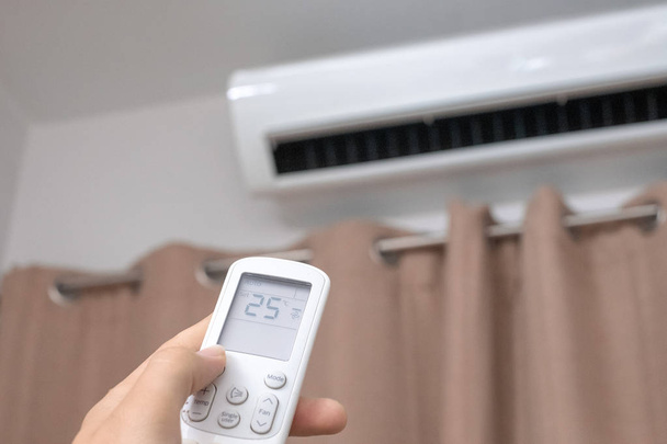 Focus ahead.Air condition control by using remote control and tu - Photo, Image