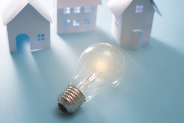Home Energy with light bulb on the blue background - Photo, Image
