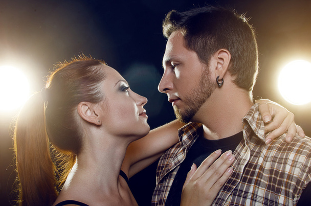 Beautiful young couple in love. The girl embraces the guy's neck - Photo, Image