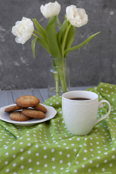 A tasty snack: a cup of coffee and a plate of cookies. - Photo, Image
