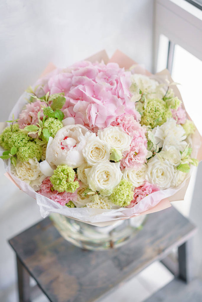 delicate, pastel coloured Small Beautiful bouquet of mixed flowers. Floral shop concept . Beautiful fresh cut bouquet. Flowers delivery - Photo, Image