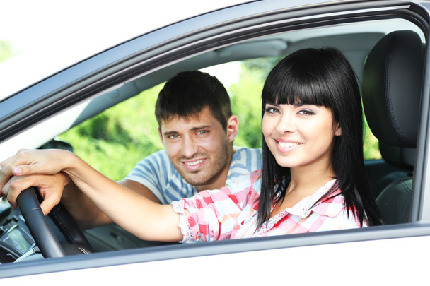 Beautiful happy young couple driving car - Zdjęcie, obraz