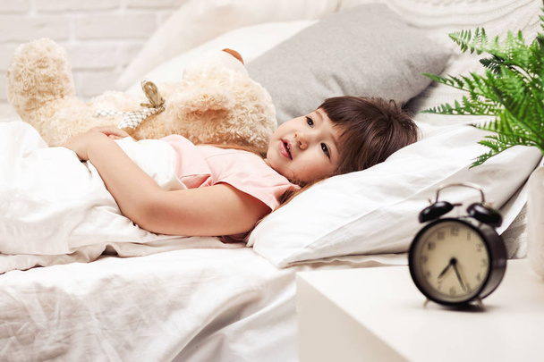 Cute little child girl sleeping with teddy bear - Photo, image