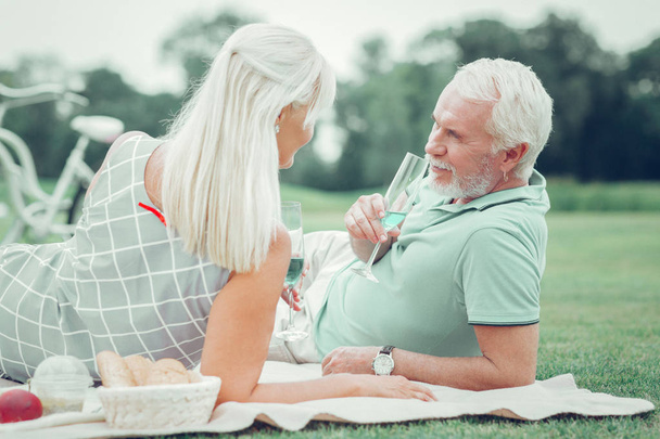 Pleasant aged couple enjoying their champagne together - Foto, imagen