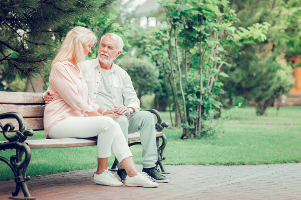Positive aged couple resting on the bench - Photo, Image