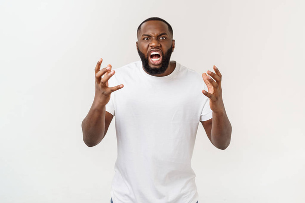 Portrait of shocked young African American man wearing white blank T-shirt looking at the camera in surprise, stunned with some incredible story. - Fotó, kép